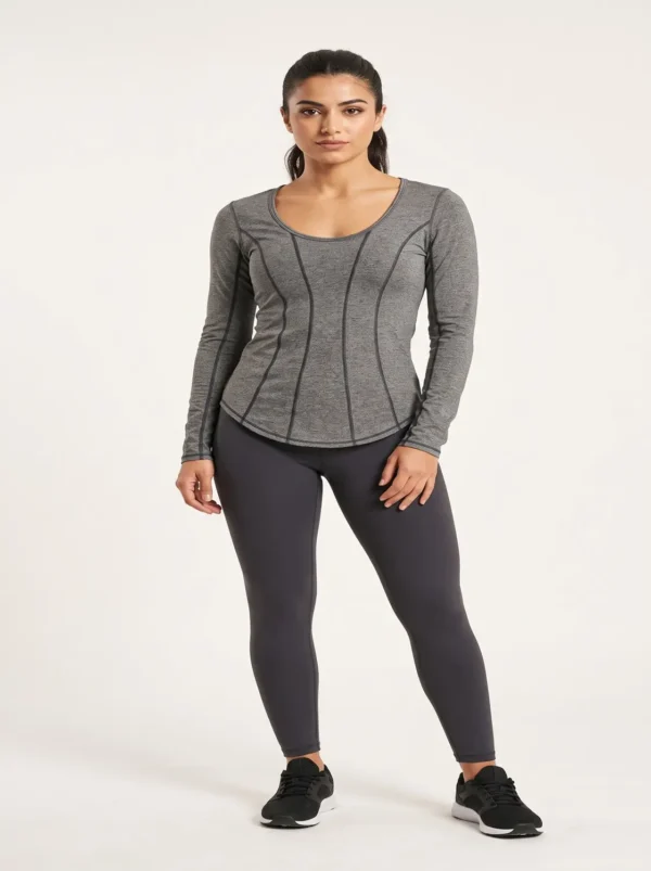 Female_model_posing_in_studio_2K_20261018181933 Heather grey long sleeve gym top with vertical contrast seams, studio view