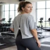 Fitness_model_posing_in_gym_2K_20261018145003 Split-back relaxed fit cropped athletic tee worn by a fitness model in the gym