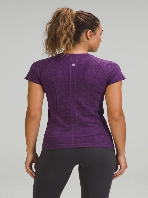 Fitness_model_posing_in_studio_2K_20261018191217 Fitness model wearing the purple Lululemon Swiftly Tech shirt in the studio