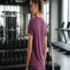 Fitness_model_wearing_athletic_s…_2K_20261018154146 Lululemon Swiftly Tech short-sleeve curve hem tee in deep purple worn by a fitness model