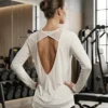Back view of the Aura open-back mesh detail long-sleeve training top showing V-back and mesh crossover strap Back view of the Aura open-back mesh detail long-sleeve training top showing V-back and mesh crossover strap