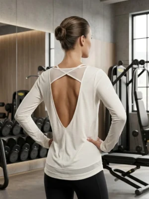 Back view of the Aura open-back mesh detail long-sleeve training top showing V-back and mesh crossover strap