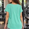 Back view of the mint green mesh-panel high-low gym t-shirt showing the longer back hem Back view of the mint green mesh-panel high-low gym t-shirt showing the longer back hem