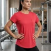 Aura Luxe everyday pocket performance tee in coral pink for women, front view with chest pocket and crew neck