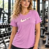 Pre-loved Nike Dri-FIT statement tee in lilac for women, front view with Nike swoosh graphic Pre-loved Nike Dri-FIT statement tee in lilac for women, front view with Nike swoosh graphic