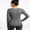 Model_posing_in_athletic_shirt_2K_20261018181900 Contoured seam athletic long sleeve top in heather grey worn by a model
