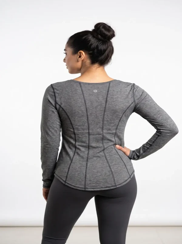Model_posing_in_athletic_shirt_2K_20261018181900 Contoured seam athletic long sleeve top in heather grey worn by a model