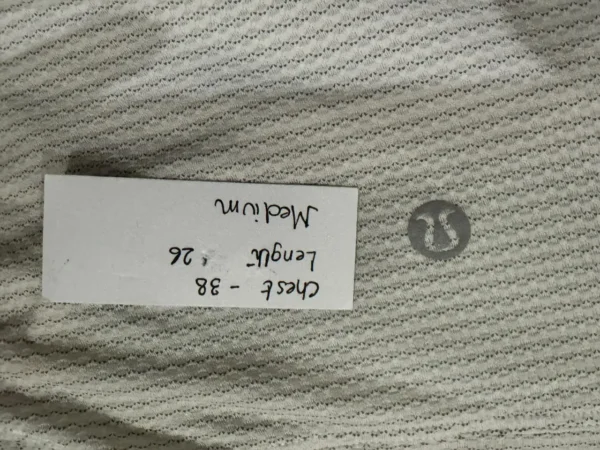 Close-up of Lululemon tie-back training shirt textured white fabric