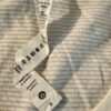 Pre-loved Lululemon Swiftly Tech long sleeve shirt care label showing size 6 Pre-loved Lululemon Swiftly Tech long sleeve shirt care label showing size 6