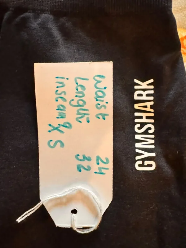 Pre-loved Gymshark women's charcoal grey high-waisted leggings full-length view Pre-loved Gymshark women's charcoal grey high-waisted leggings full-length view