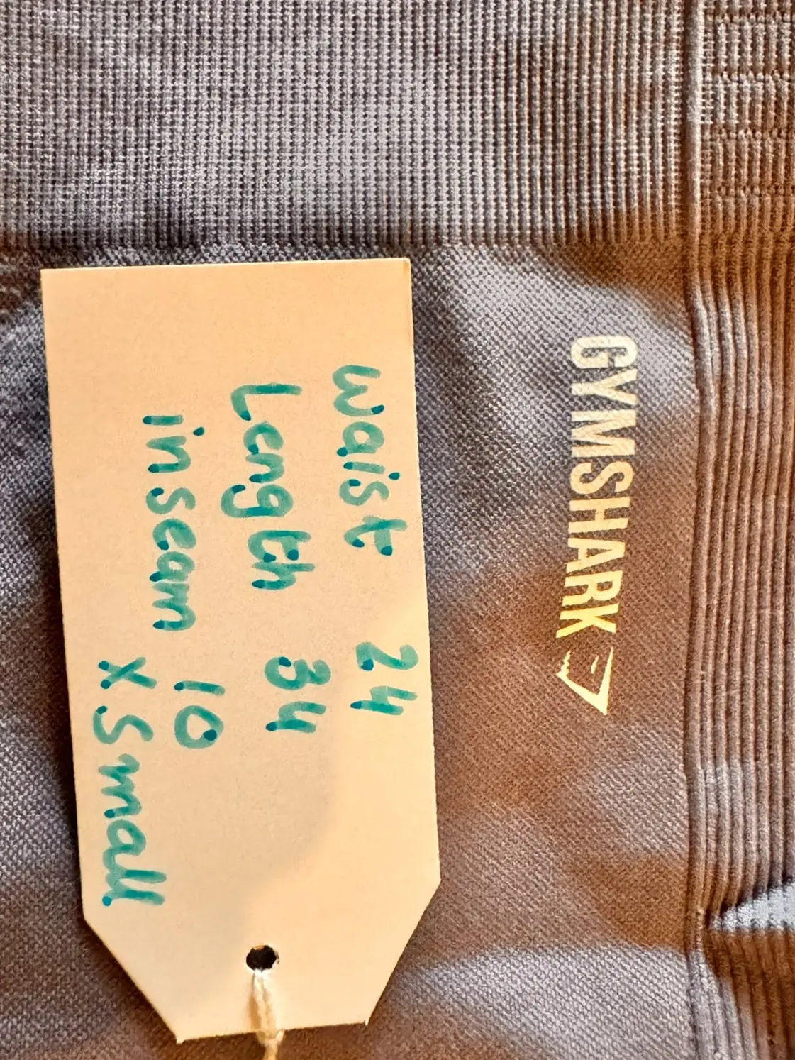 Gymshark logo and textured seamless knit on pre-loved dusty mauve leggings with size tag