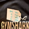 Close-up of the Gymshark logo on pre-loved black training leggings