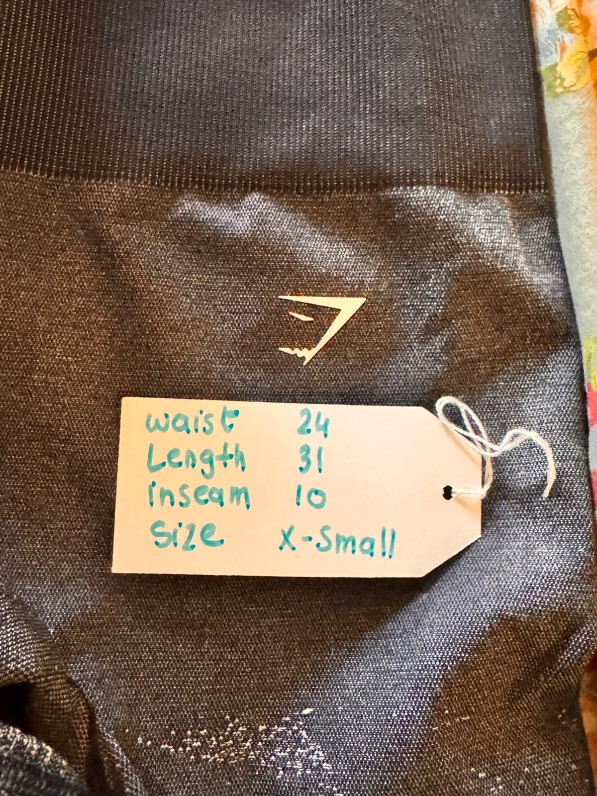 Close-up of the textured seamless knit on pre-loved Gymshark sage ombre leggings