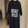 Black Break the Rules graphic print t-shirt on a hanger, front view