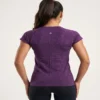 Woman_posing_in_athletic_shirt_2K_20261018191254 Side view of the purple Lululemon Swiftly Tech 2.0 running shirt