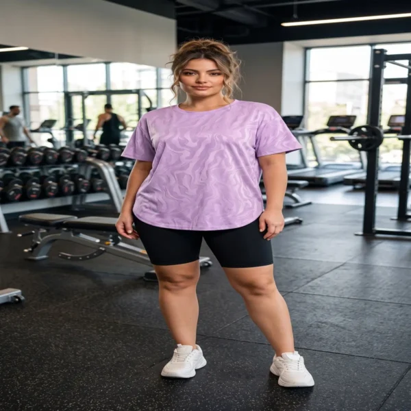 Woman_standing_in_gym_2K_20261015202116 Lavender Glow Textured Active Tee worn by woman in gym