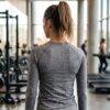 PRE-LOVED Lululemon Ruched V-Neck Athletic Long Sleeve Top Side view of the heather grey ruched v-neck long sleeve gym top