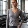 PRE-LOVED Lululemon Ruched V-Neck Athletic Long Sleeve Top Ruched v-neck athletic long sleeve top in heather grey worn by a fitness model